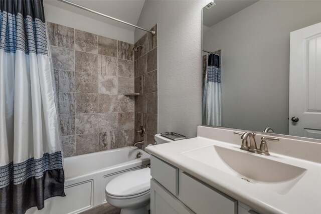 full bathroom featuring toilet, vanity, and shower / bath combo with shower curtain