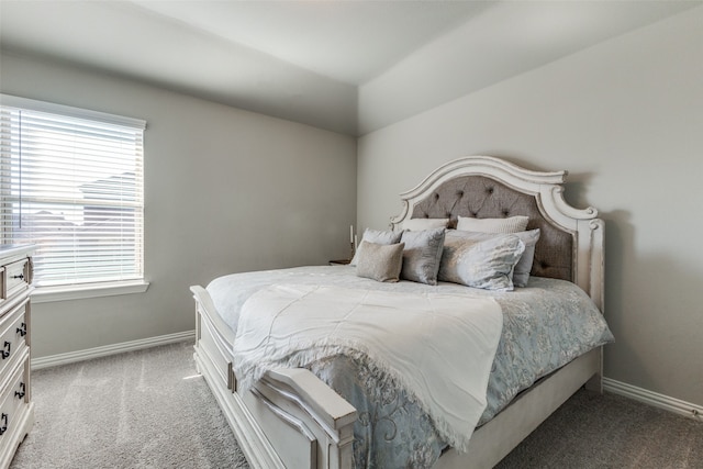 bedroom featuring carpet flooring, multiple windows, and vaulted ceiling