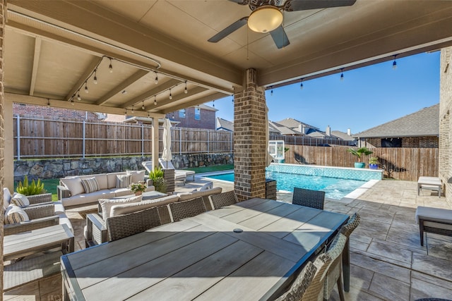 view of patio with a fenced in pool, outdoor lounge area, and ceiling fan