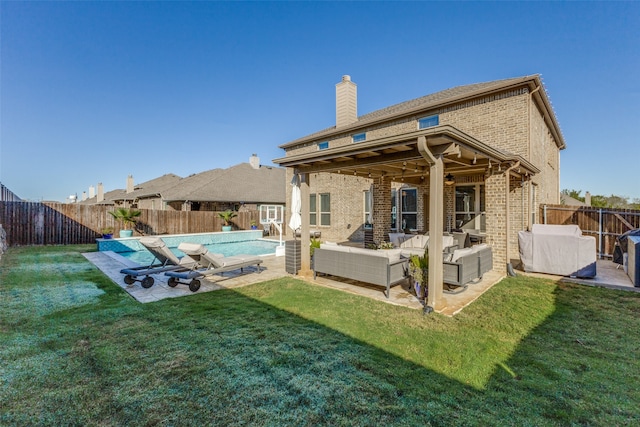 rear view of property featuring a lawn, outdoor lounge area, and a patio