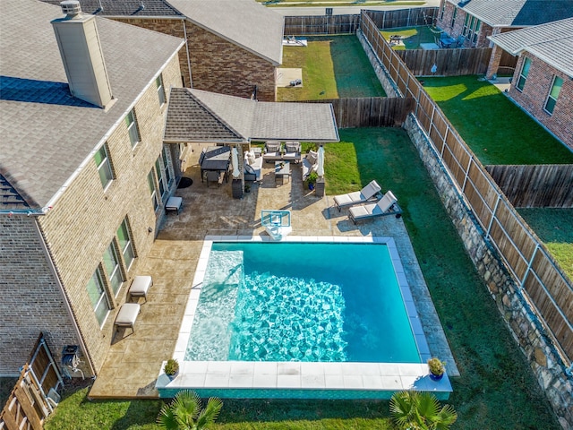 view of swimming pool with a yard and a patio