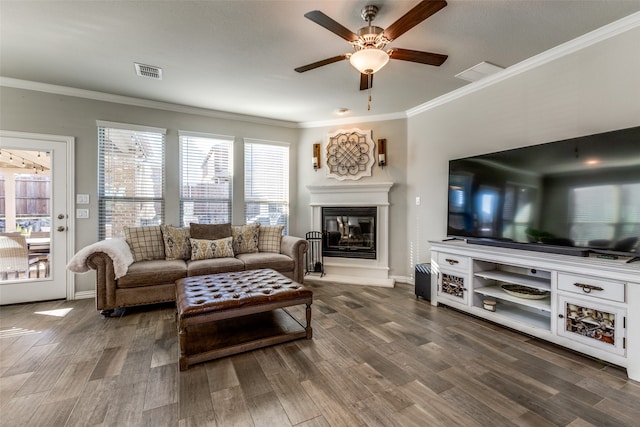 living room with ornamental molding, hardwood / wood-style flooring, and ceiling fan