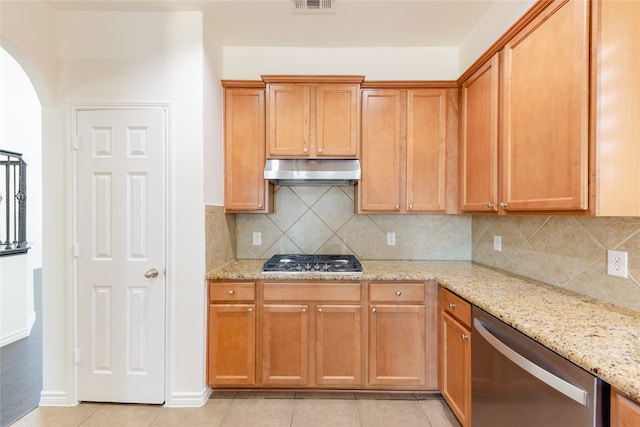 kitchen with stainless steel appliances, light tile patterned flooring, decorative backsplash, and light stone counters