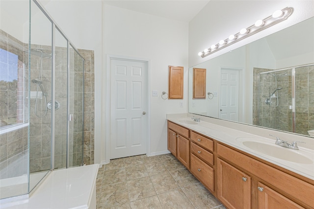 bathroom with an enclosed shower, vanity, and tile patterned flooring