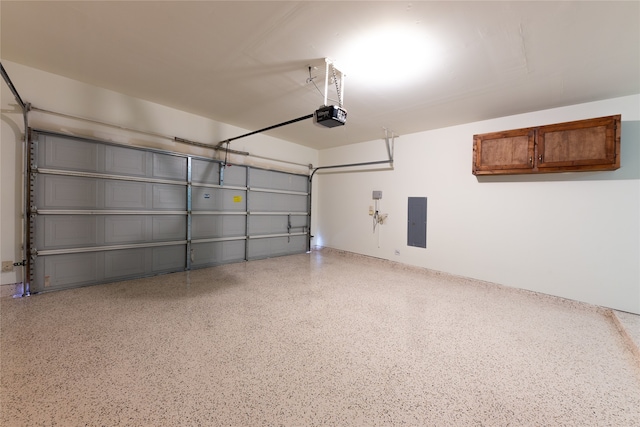 garage featuring electric panel and a garage door opener