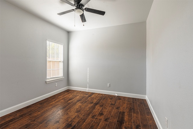 empty room with dark hardwood / wood-style flooring and ceiling fan