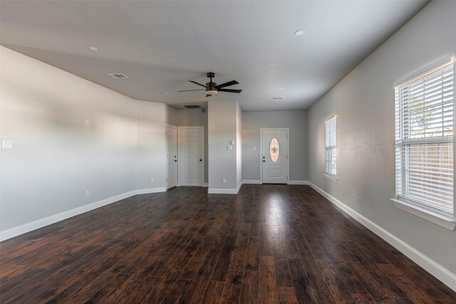 interior space with dark wood-type flooring and ceiling fan