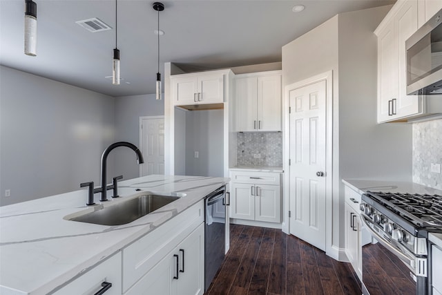 kitchen with stainless steel appliances, white cabinets, sink, and dark hardwood / wood-style flooring