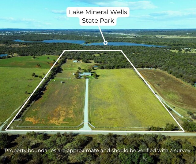 birds eye view of property with a rural view and a water view