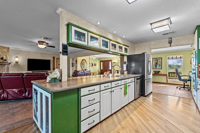 kitchen featuring white cabinets, light hardwood / wood-style flooring, sink, and ceiling fan