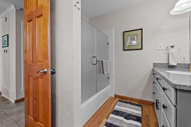 bathroom with hardwood / wood-style flooring, vanity, and shower / bathing tub combination