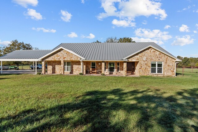 rear view of property featuring a yard