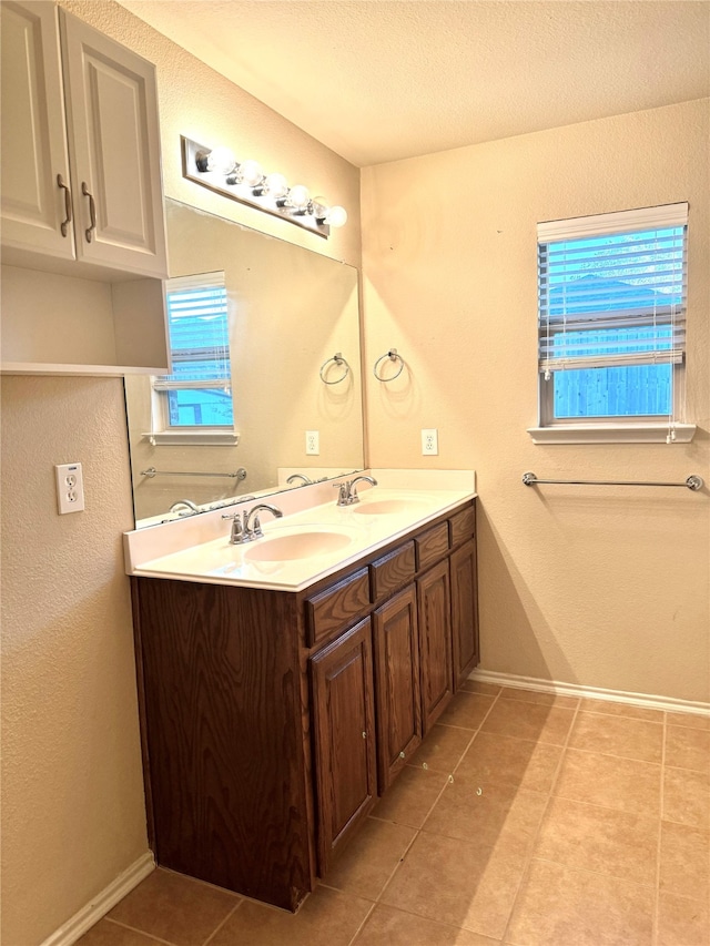 bathroom featuring vanity, tile patterned flooring, and a textured ceiling