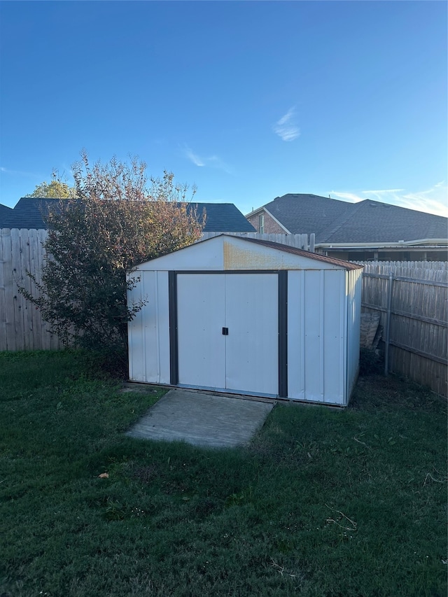 view of outbuilding with a yard