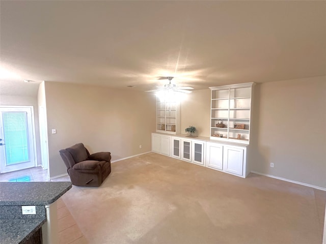 sitting room with ceiling fan and light colored carpet