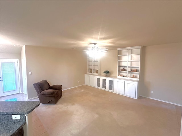 living area featuring ceiling fan and light carpet