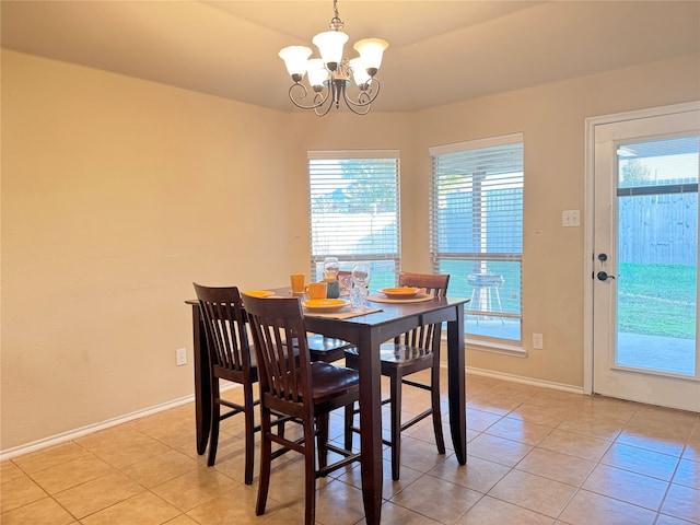 dining room with an inviting chandelier and light tile patterned floors