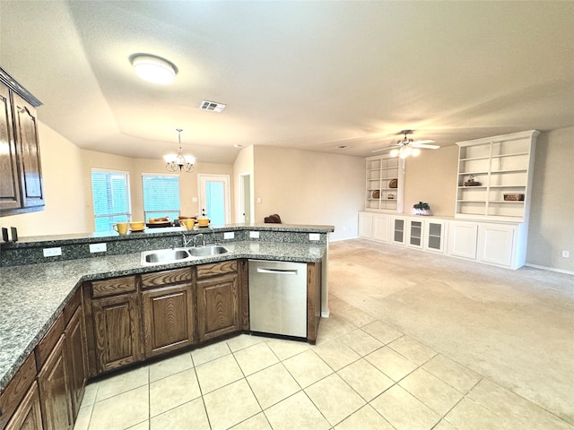 kitchen with dishwasher, sink, hanging light fixtures, light colored carpet, and built in shelves