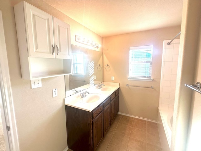 bathroom featuring tile patterned flooring, vanity, a healthy amount of sunlight, and shower / bathtub combination