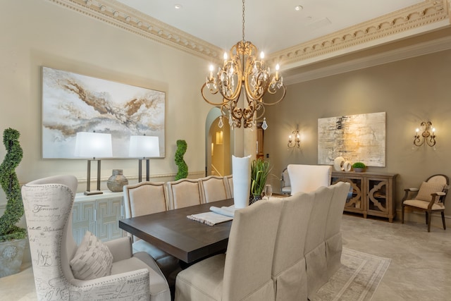 dining space featuring ornamental molding, a high ceiling, and a chandelier