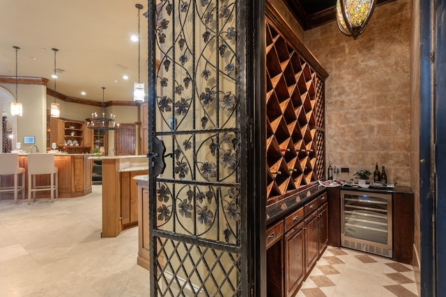 wine cellar featuring bar area, beverage cooler, tile walls, and ornamental molding