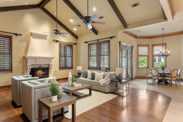 living room featuring beamed ceiling, ceiling fan with notable chandelier, wood-type flooring, and high vaulted ceiling