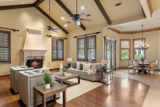 living room featuring beam ceiling, wood-type flooring, a healthy amount of sunlight, and high vaulted ceiling