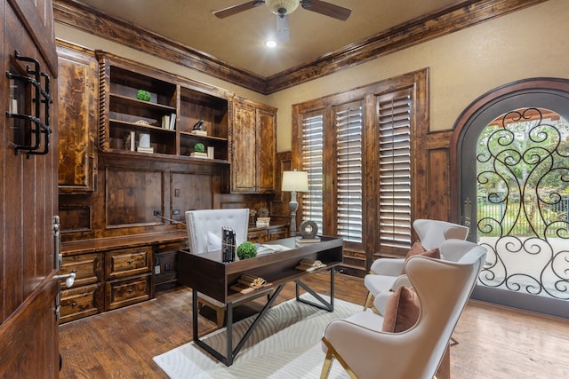 office area with a healthy amount of sunlight, crown molding, ceiling fan, and wood-type flooring