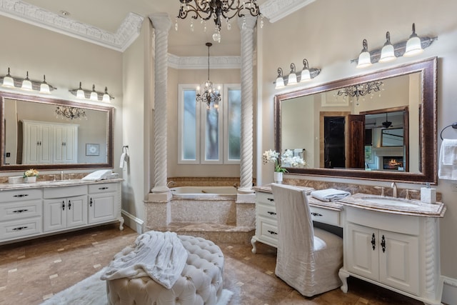 bathroom with tiled bath, vanity, decorative columns, and crown molding