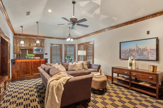 carpeted living room featuring ceiling fan with notable chandelier, vaulted ceiling, and ornamental molding