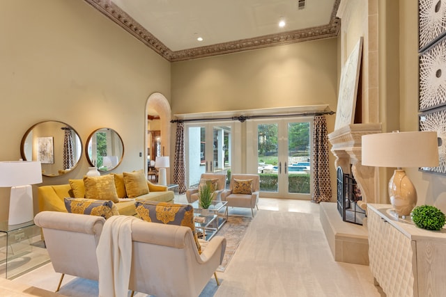 living room with french doors, a towering ceiling, ornamental molding, and light tile patterned flooring