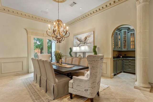 dining space featuring decorative columns, a high ceiling, and a notable chandelier