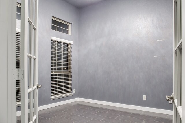 empty room featuring a towering ceiling