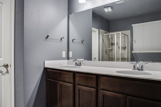 bathroom featuring walk in shower and vanity