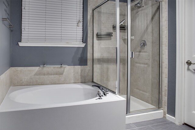 bathroom featuring separate shower and tub