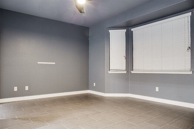 spare room featuring light hardwood / wood-style floors and ceiling fan