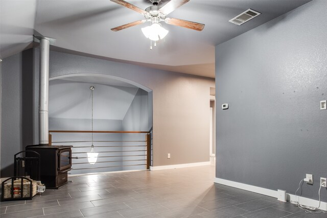 empty room featuring dark hardwood / wood-style flooring, vaulted ceiling, and ceiling fan