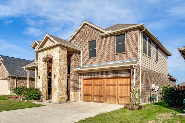 view of front of property with a garage and a front lawn