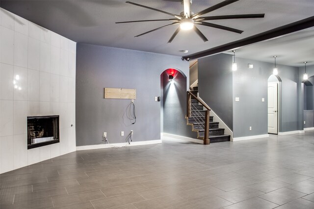 unfurnished living room featuring ceiling fan