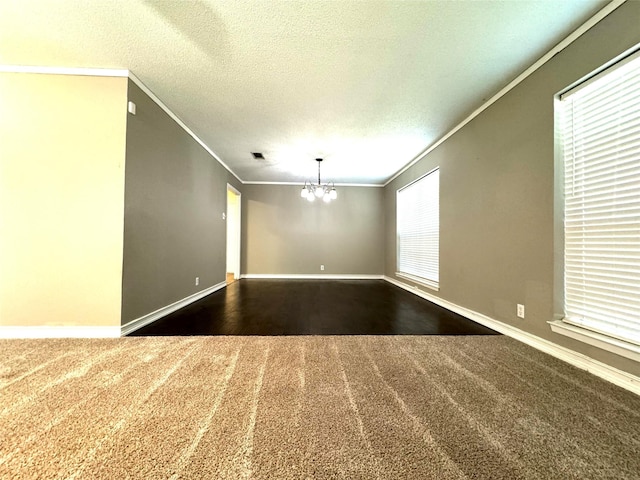 unfurnished room featuring an inviting chandelier, ornamental molding, and a textured ceiling