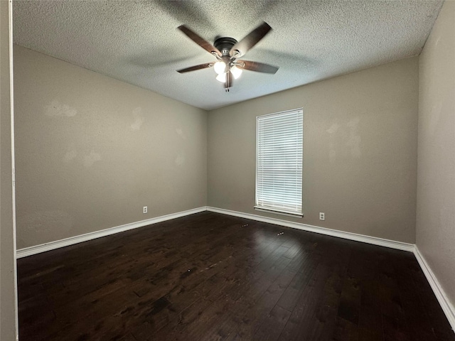 empty room featuring ceiling fan, dark hardwood / wood-style flooring, and a textured ceiling