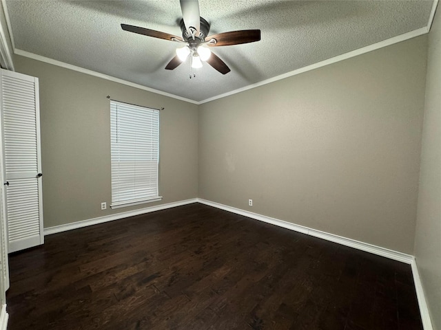 empty room with ceiling fan, dark wood-type flooring, crown molding, and a textured ceiling