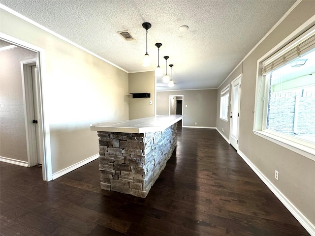 bar with ornamental molding, dark hardwood / wood-style flooring, and hanging light fixtures