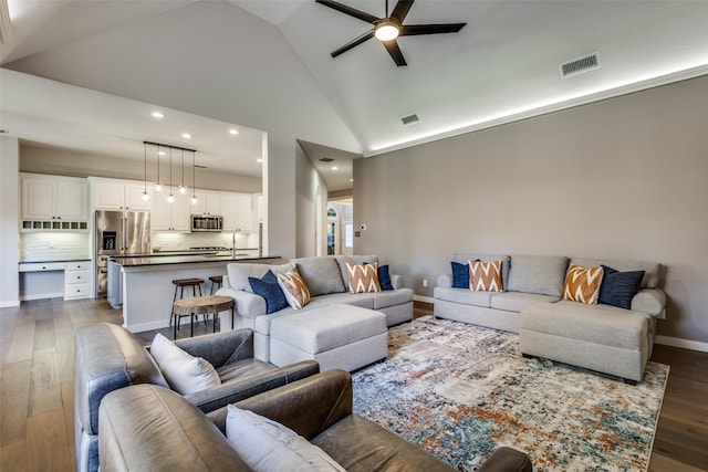 living room featuring dark hardwood / wood-style floors, ceiling fan, sink, and high vaulted ceiling