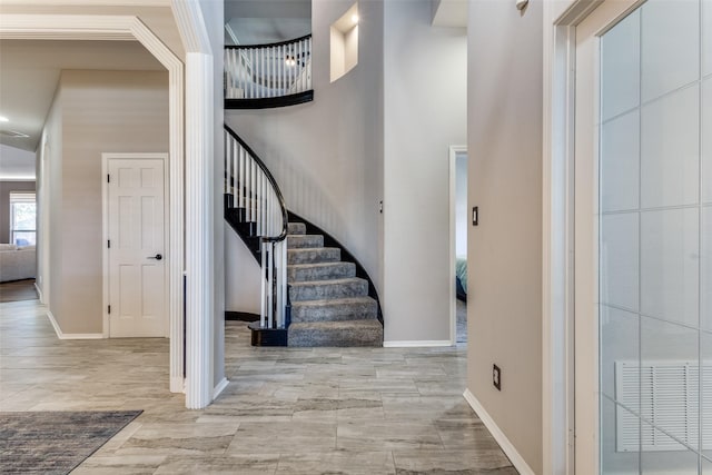 foyer entrance featuring a towering ceiling