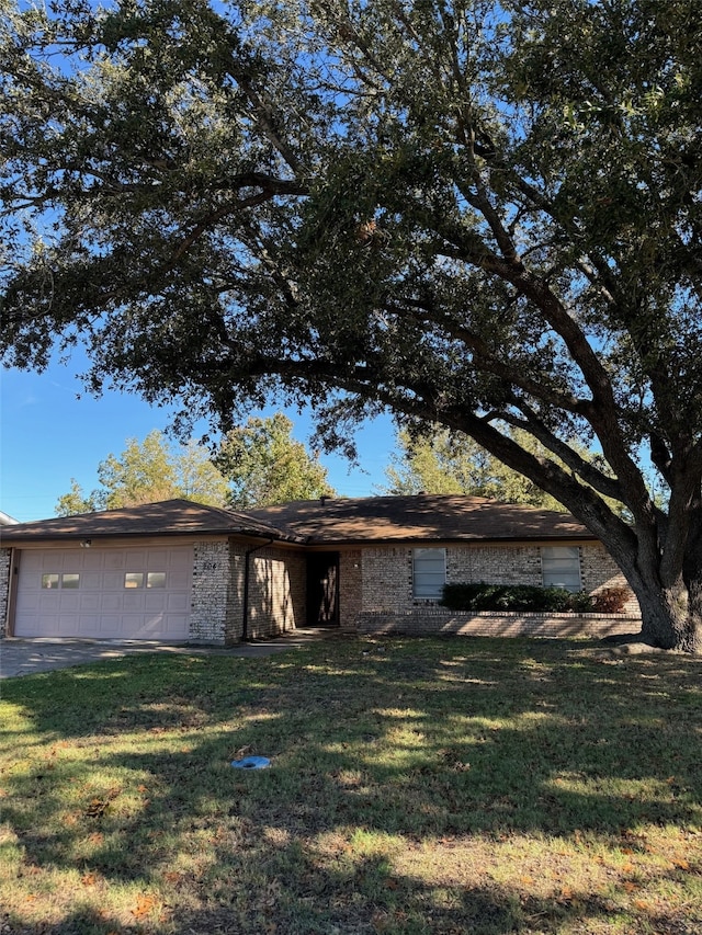 view of front of home with a garage and a front lawn