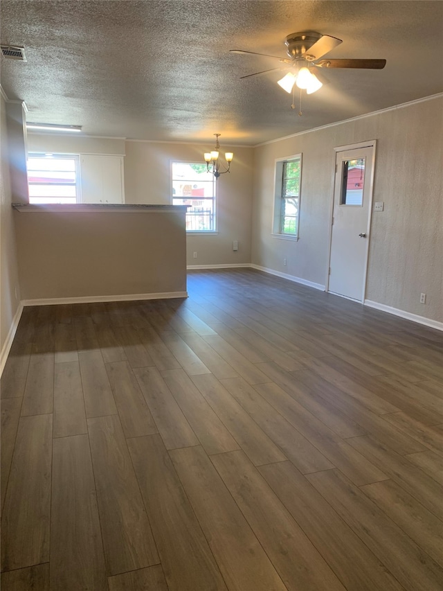 empty room with ceiling fan with notable chandelier, dark hardwood / wood-style flooring, and a textured ceiling