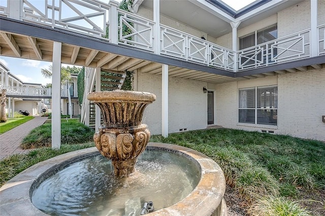 view of exterior entry featuring a balcony