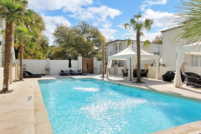 view of swimming pool featuring a patio and a gazebo