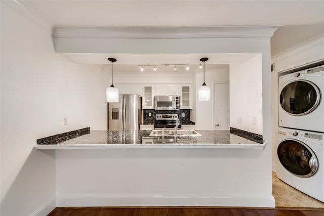 kitchen featuring stainless steel appliances, wood-type flooring, white cabinetry, and kitchen peninsula